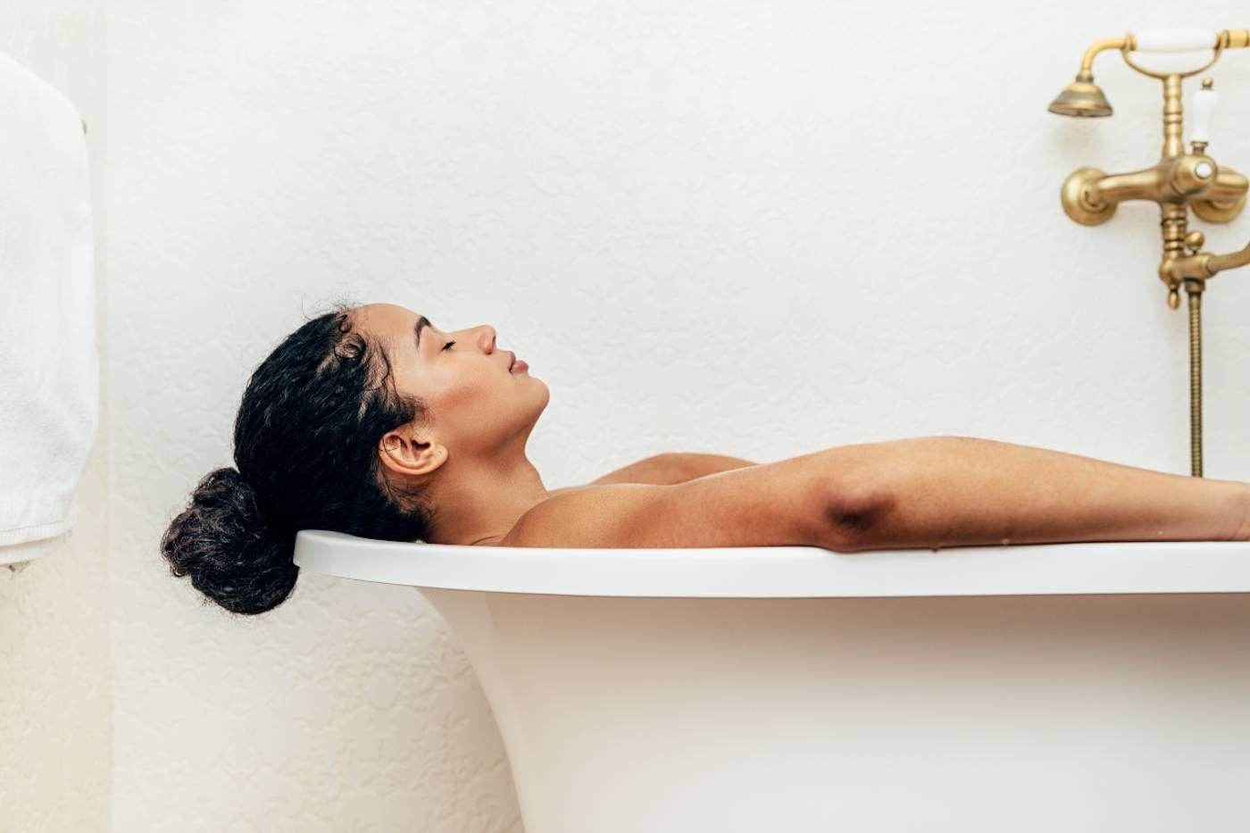Woman relaxing in a bathtub