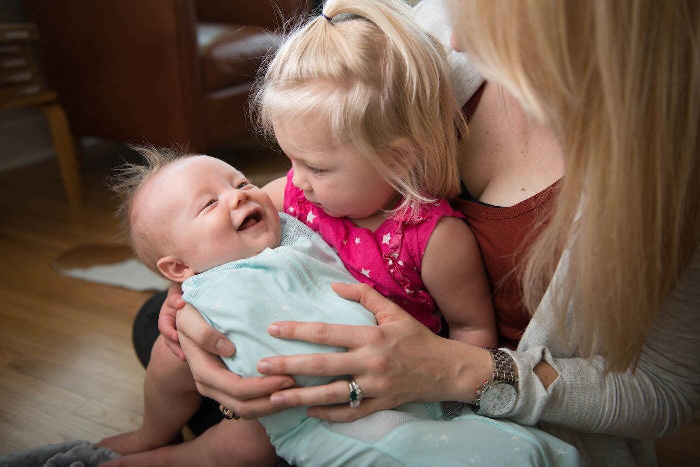 mother with toddler and swaddled baby