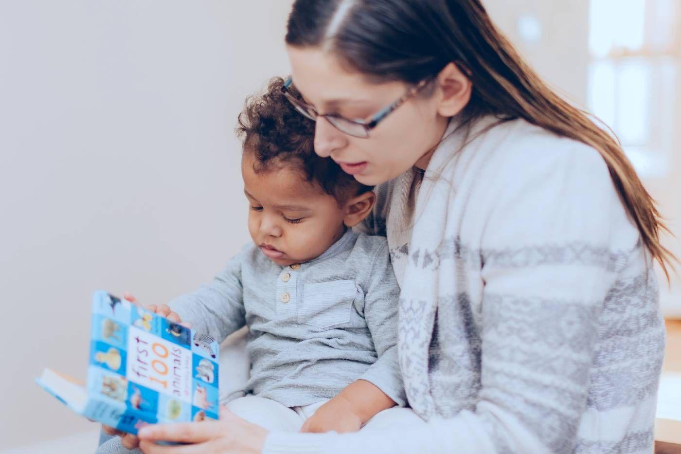 mum reading book to her baby