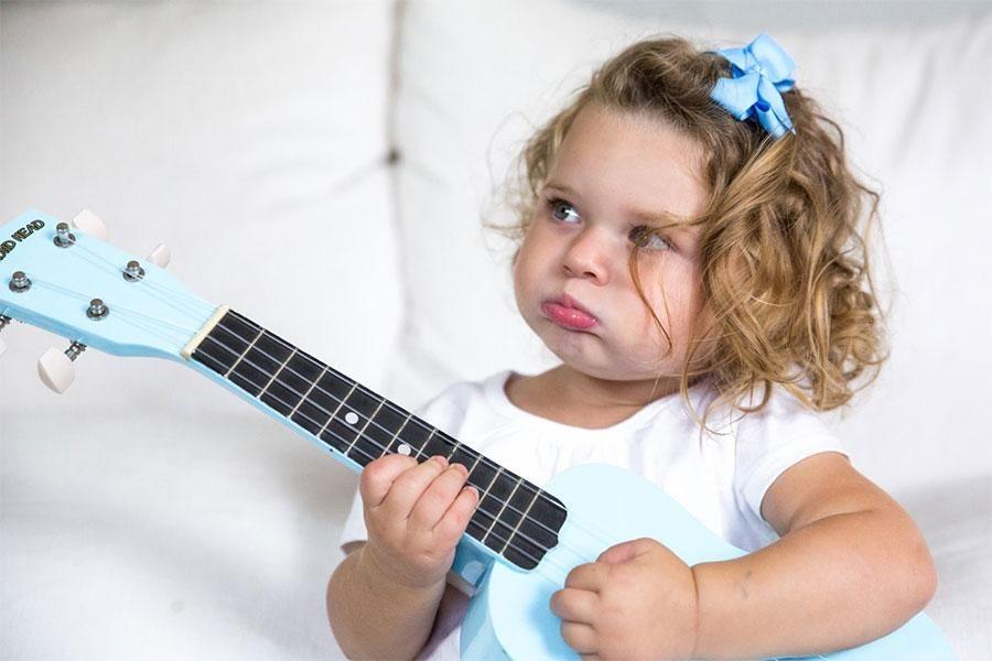 Toddler with a toy guitar
