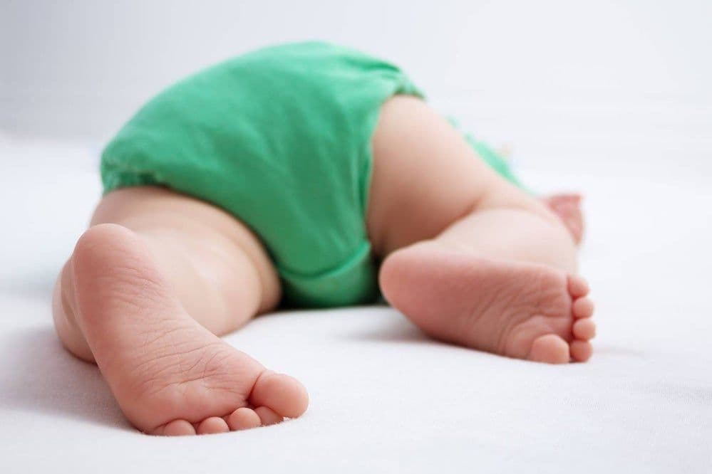 Rear view of baby sleeping on stomach