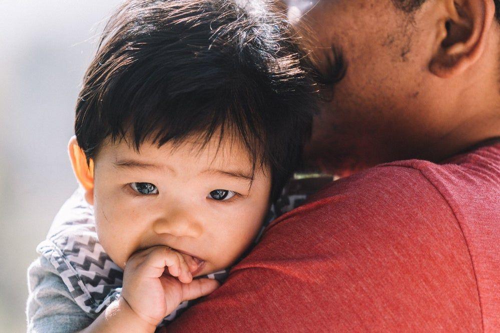 Baby boy chews on his fingers
